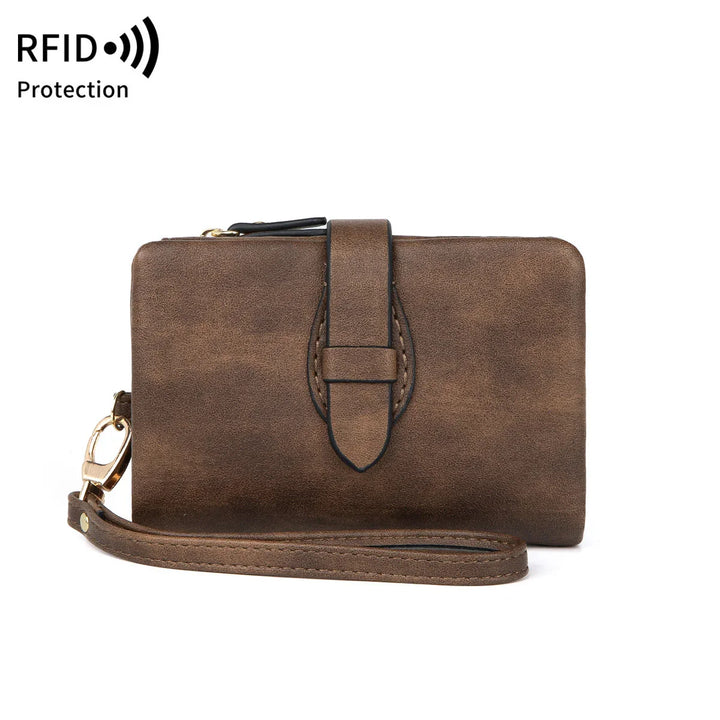 Brown leather wristlet wallet with strap and RFID protection logo on white background