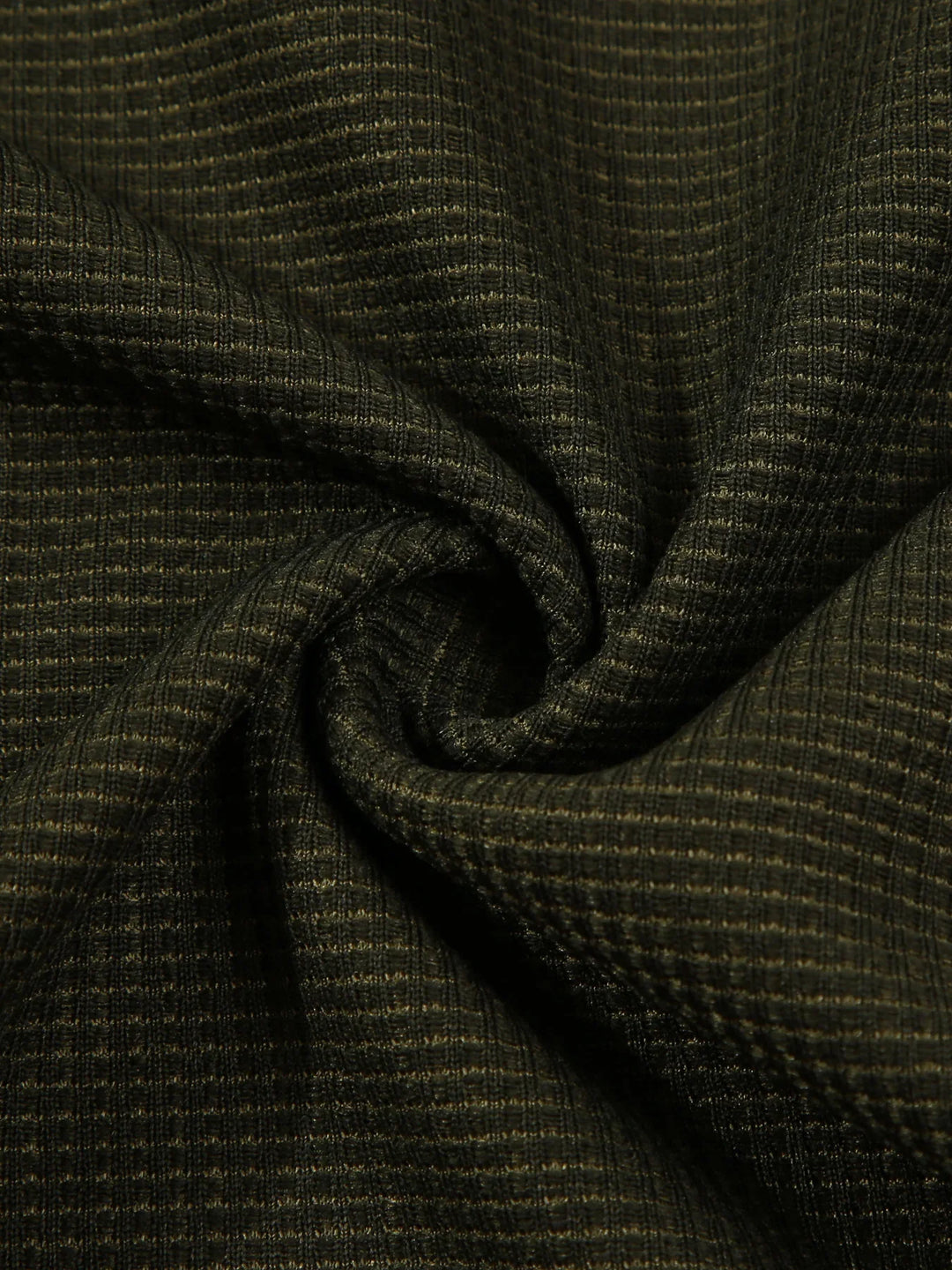 Close-up of dark green textured fabric with fine grid pattern, twisted to show weave detail