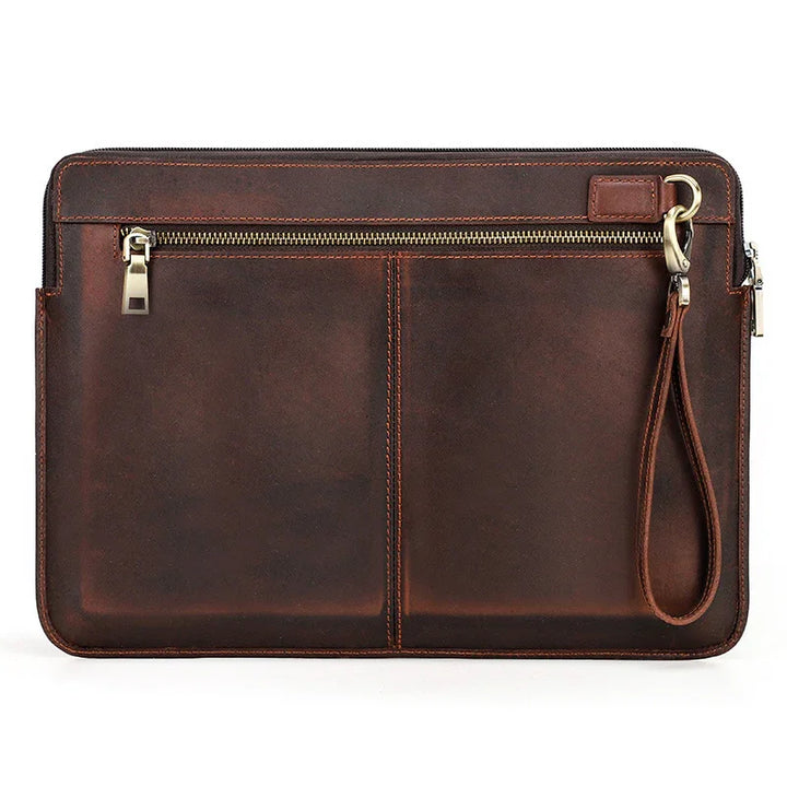 brown leather wristlet clutch with zipper pocket and detachable strap on white background