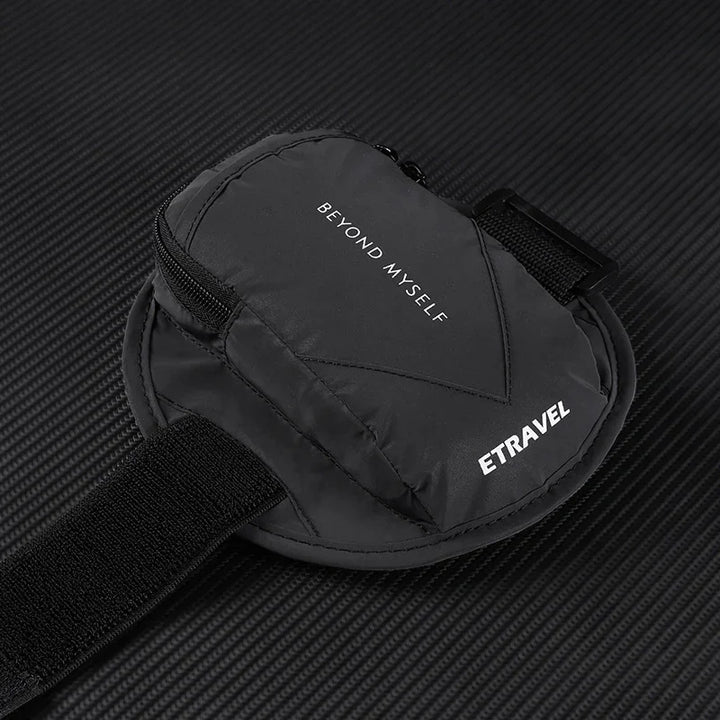 Black ETRAVEL travel pouch with zipper on textured surface, text 'BEYOND MYSELF' visible.