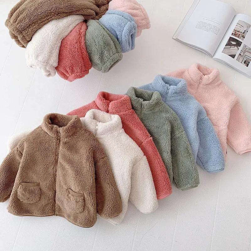 Soft fluffy fleece jackets in brown, white, pink, green, blue, and coral colors, with front pockets