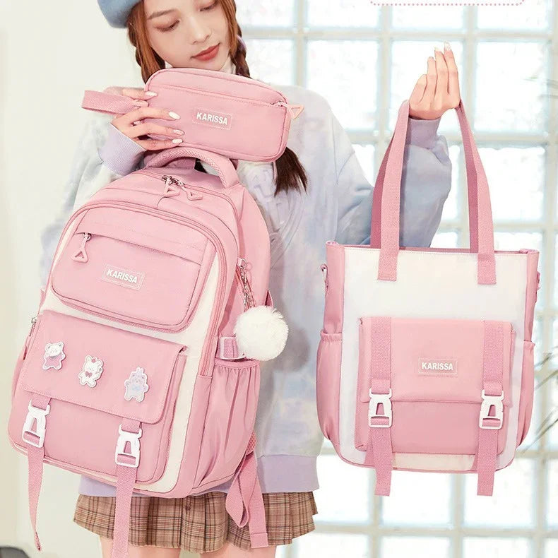 Woman holding pink KARISSA backpack, pencil case, and pink and white tote bag with cartoon pins