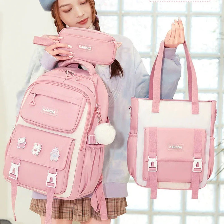 Woman holding pink KARISSA backpack, pencil case, and pink and white tote bag with cartoon pins