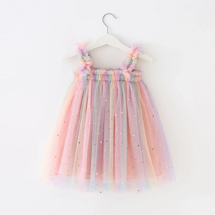 Pastel rainbow tulle girls dress with gold stars hanging on white wooden hanger