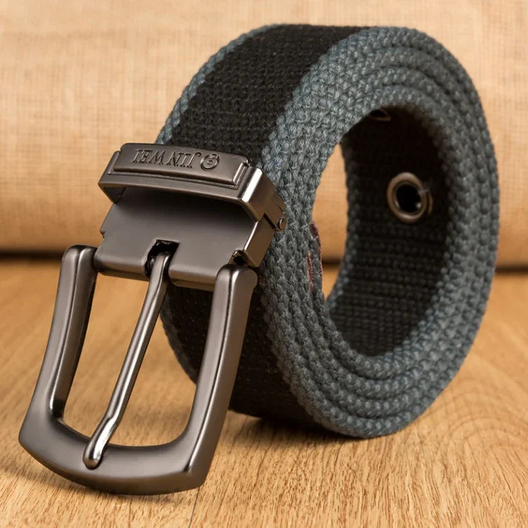 Black and gray woven fabric belt with metal buckle on wooden surface