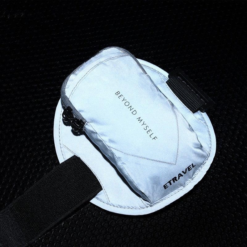 Reflective silver travel pouch with 'BEYOND MYSELF' and 'ETRAVEL' on textured black surface