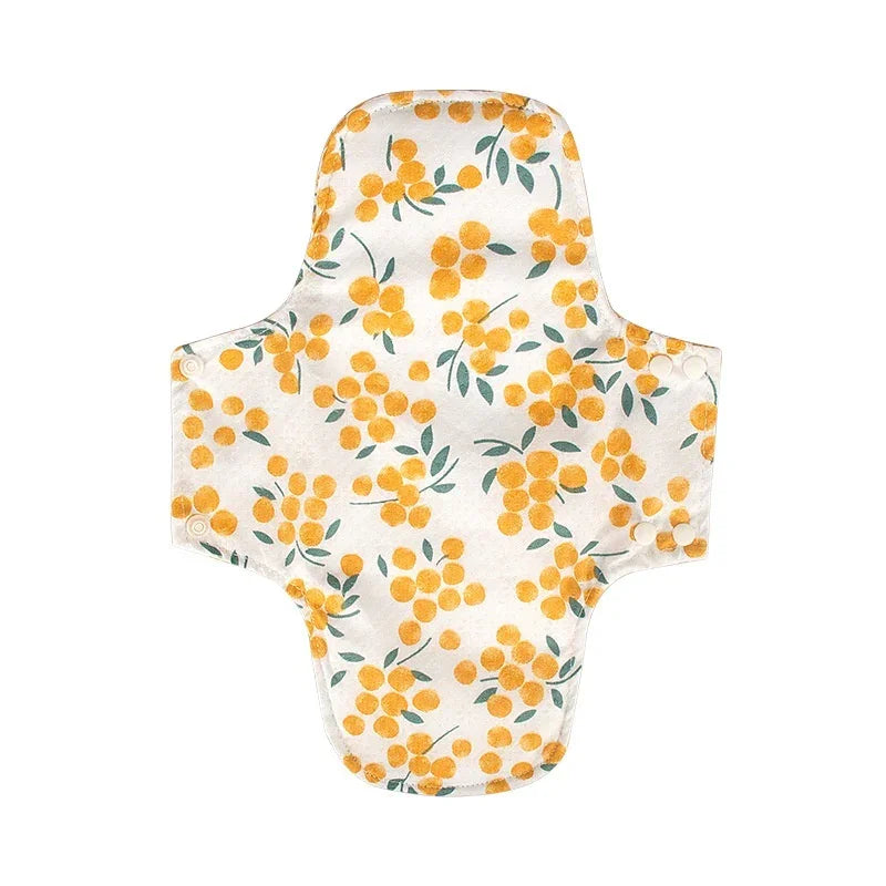 Reusable cloth menstrual pad with yellow floral pattern and snap buttons on sides