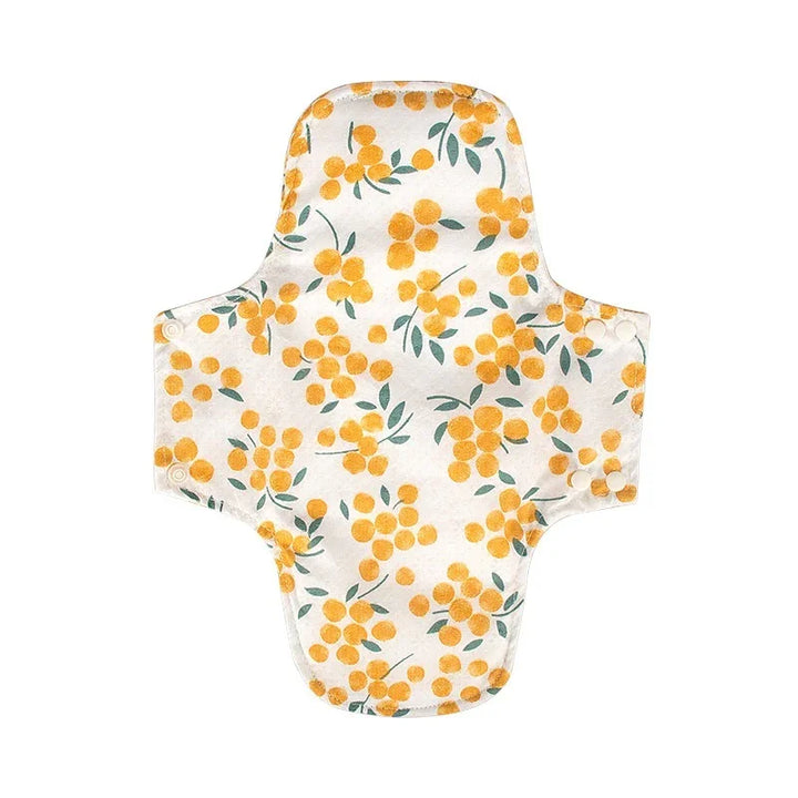 Reusable cloth menstrual pad with yellow floral pattern and snap buttons on sides