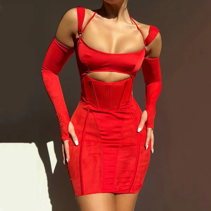 Woman wearing a red cutout bodycon mini dress with matching arm sleeves against a plain dark background