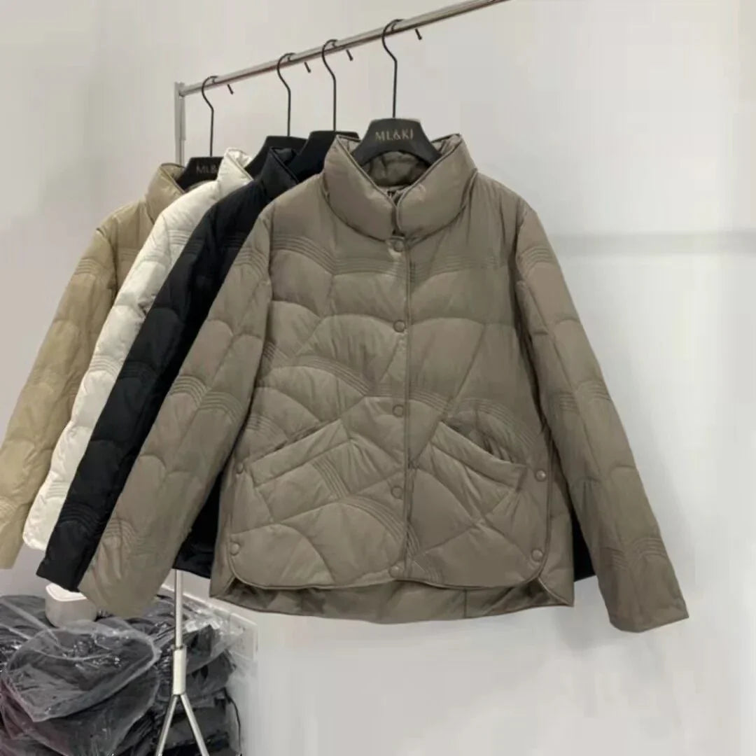 MLAKI brand quilted puffer jackets in beige, white, black, and taupe hanging on rack