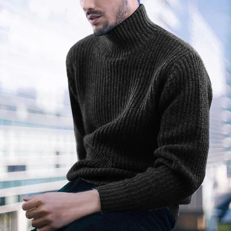 man wearing black ribbed knit turtleneck sweater, sitting by window with modern city view