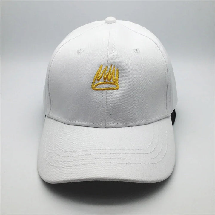 White baseball cap with yellow embroidered crown logo on front against a plain background