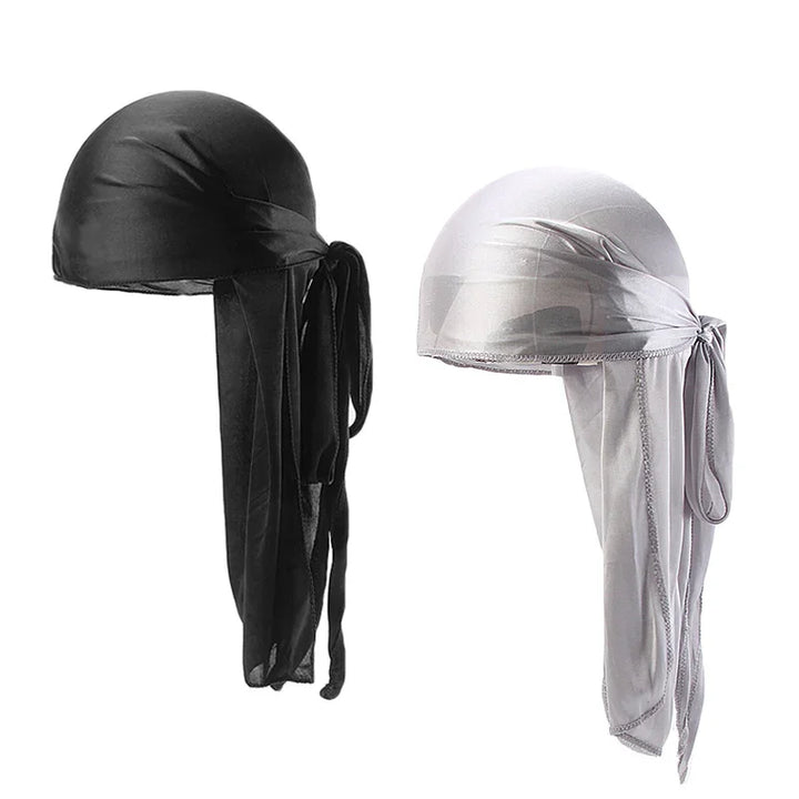 Black and white silky durag hats with long tails and knots on plain white background