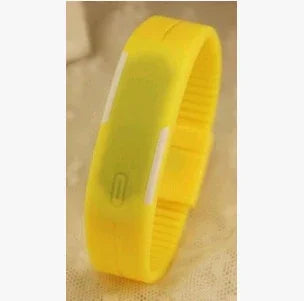 Yellow silicone fitness tracker wristband with adjustable strap on beige background