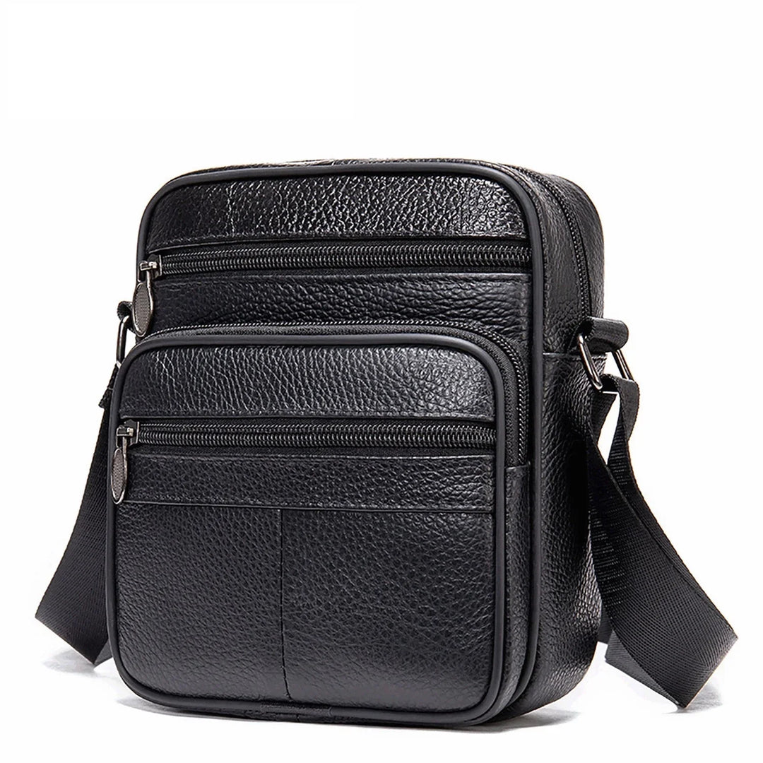 Black textured leather crossbody bag with multiple zippered compartments and adjustable strap