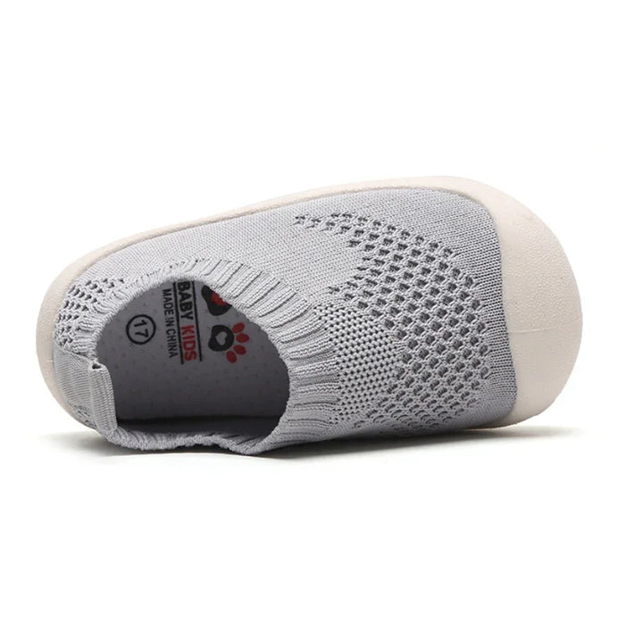 Light grey baby kids slip-on shoe with knitted upper and white rubber toe cap, size 17