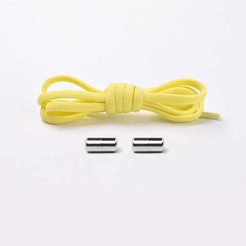 Yellow elastic shoelace with two silver magnetic shoelace clasps on white background