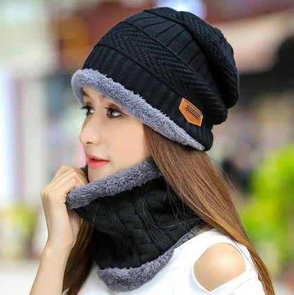 Woman wearing black knit winter hat and matching fleece-lined neck warmer in outdoor setting