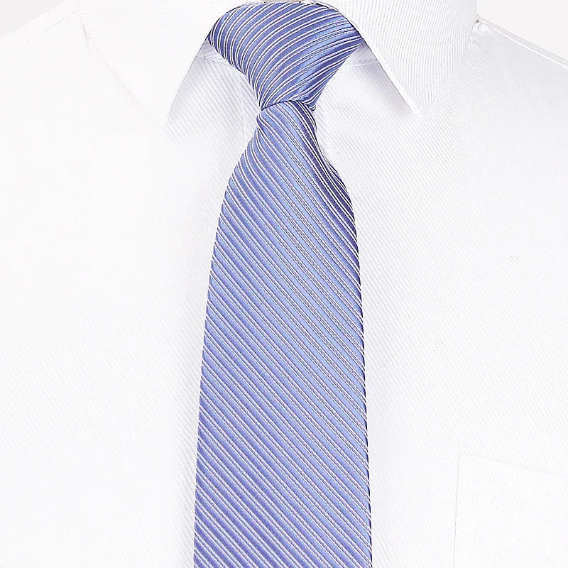 Close-up of a blue striped necktie worn over a white dress shirt collar