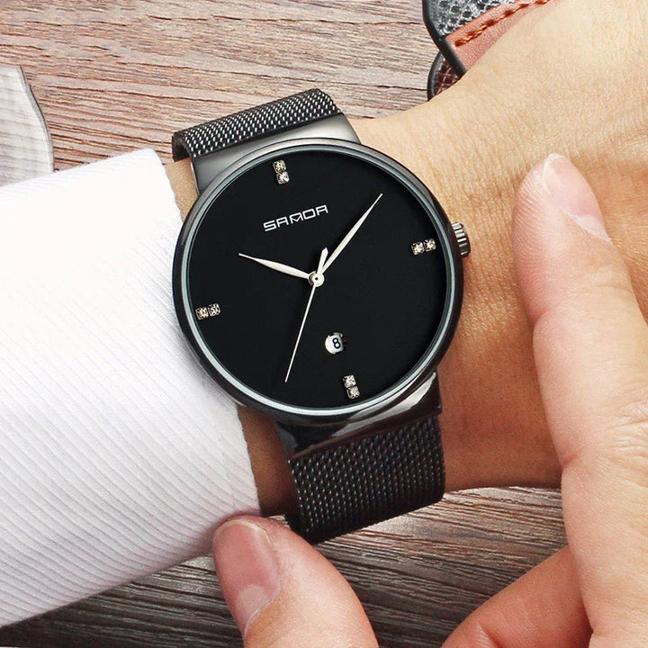 SANDA black minimalist wristwatch with diamond markers and mesh strap on wrist