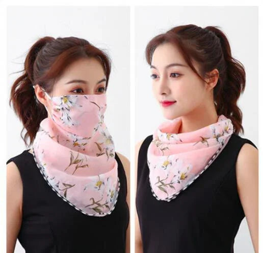 Woman wearing pink floral bandana scarf styled as face mask and neck accessory, black sleeveless top