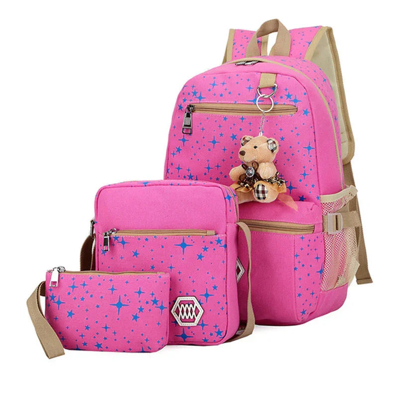 Pink backpack set with blue star pattern, teddy bear keychain, and matching crossbody and pencil pouch