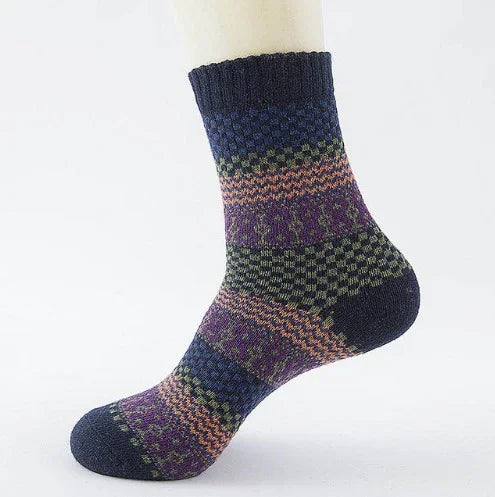 Colorful patterned wool sock featuring blue, purple, green, and orange stripes on mannequin foot
