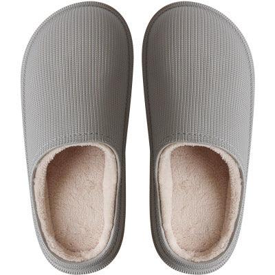 Pair of gray cozy indoor slippers with soft beige fleece lining top view