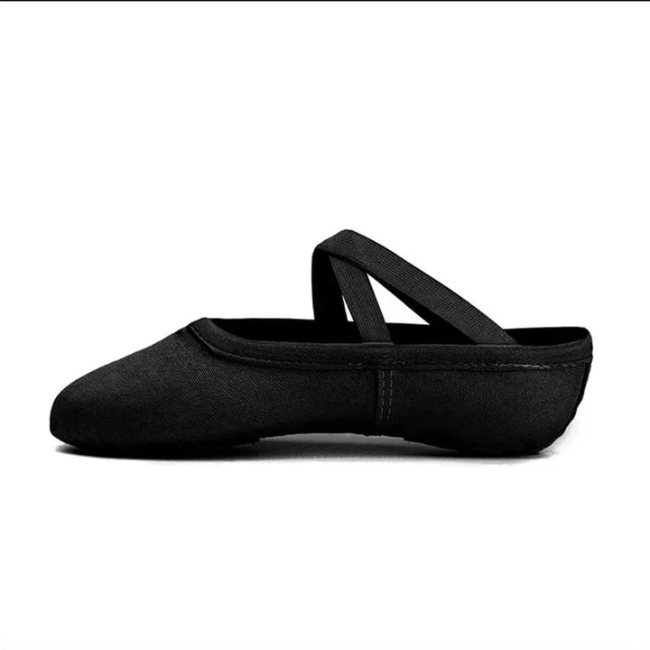 Black canvas ballet shoe with crossed elastic straps on a white background