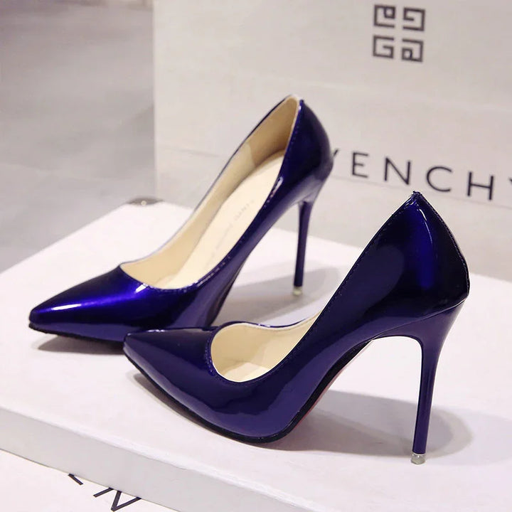Pair of shiny blue patent leather high heel pumps on a white Givenchy box