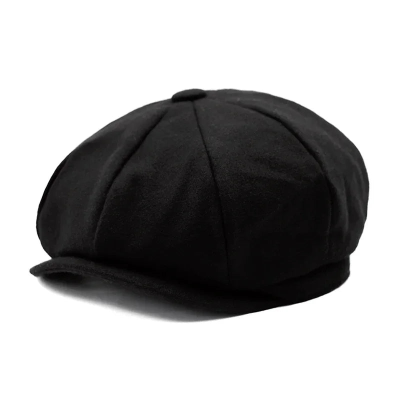 Black wool newsboy cap with eight panels and button top on white background