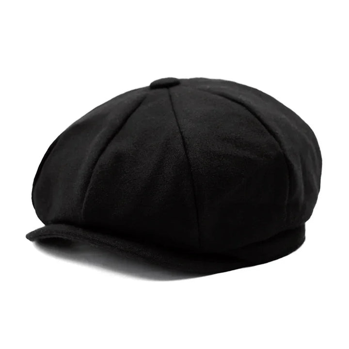Black wool newsboy cap with eight panels and button top on white background