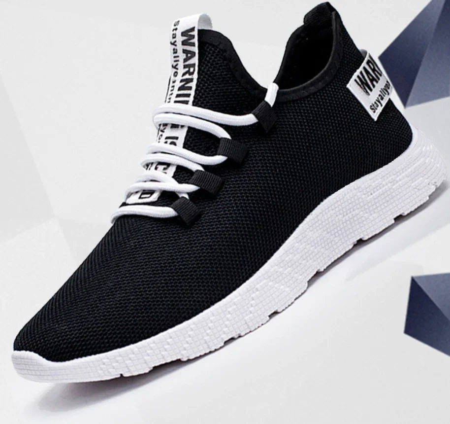 Black mesh sneaker with white sole and white laces featuring 'WARNING' text on tongue and heel tab