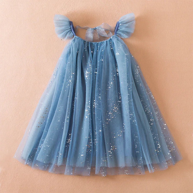 Blue tulle kids dress with sparkly silver dots and puff sleeves on peach background