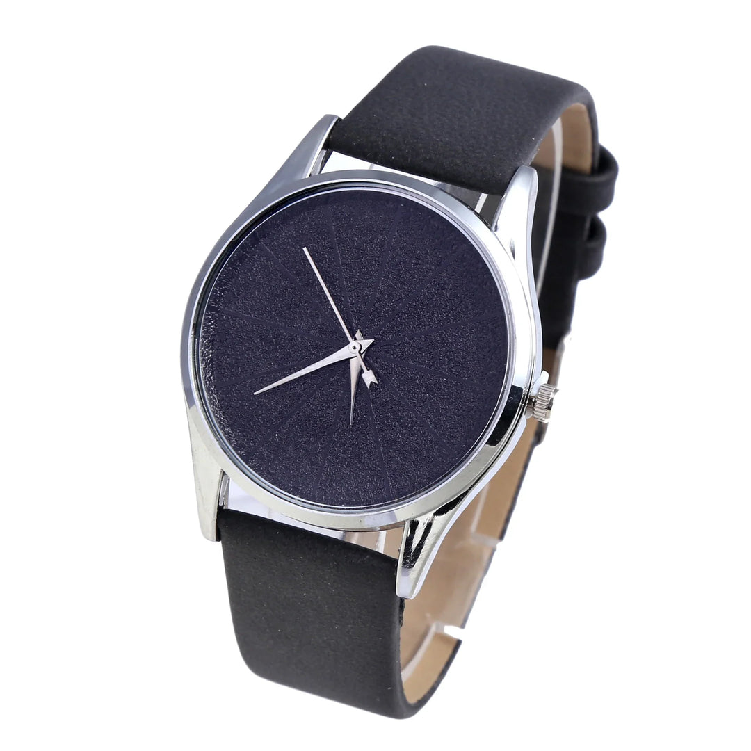 Minimalist wristwatch with black textured dial, silver case, and black leather strap