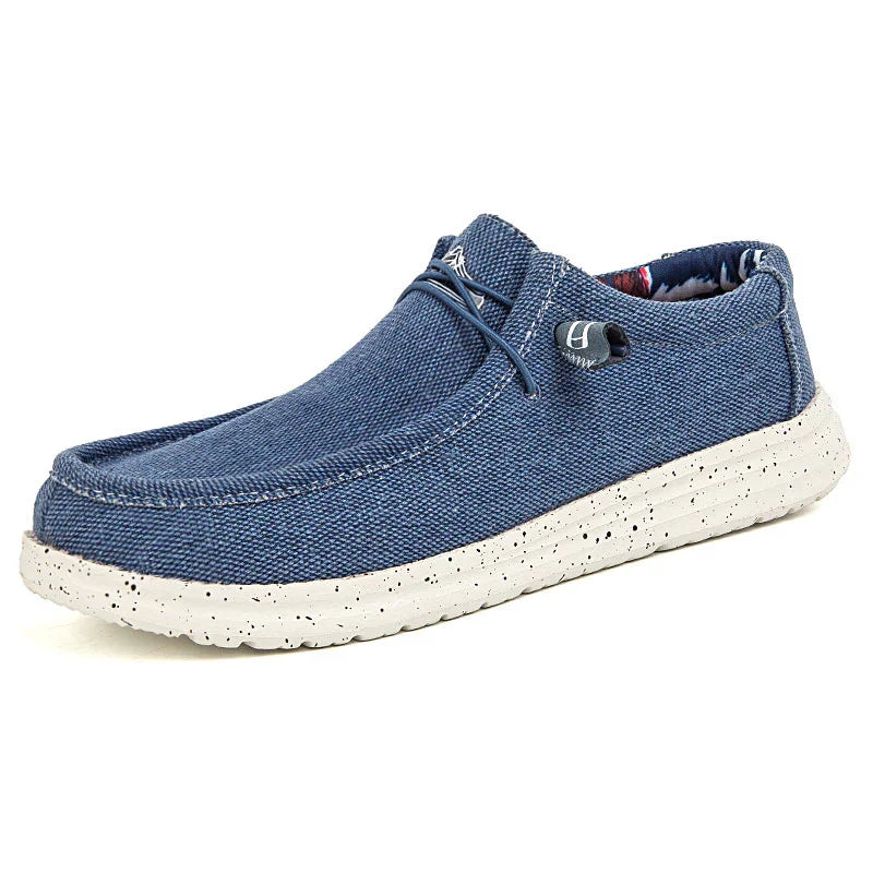 Men's casual blue fabric slip-on shoe with white speckled sole and lace detail