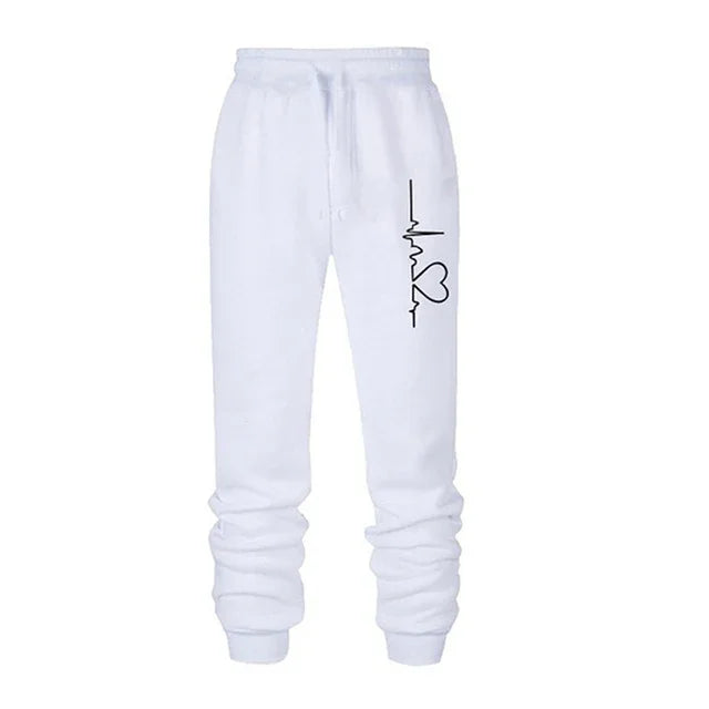 White jogger sweatpants with black heartbeat and heart line graphic on thigh