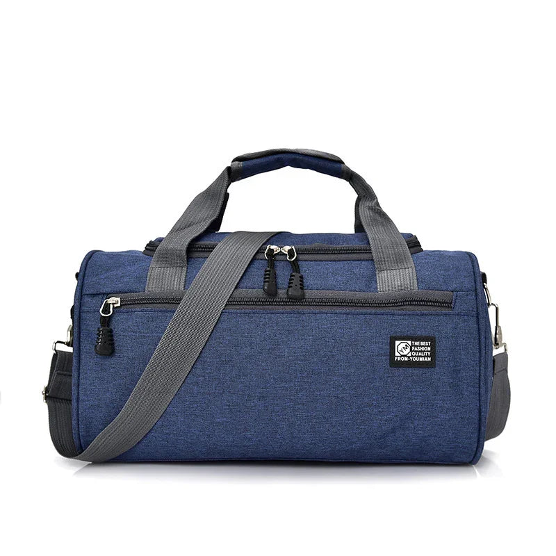 Blue fabric duffel gym bag with gray straps and front zipper pocket on white background