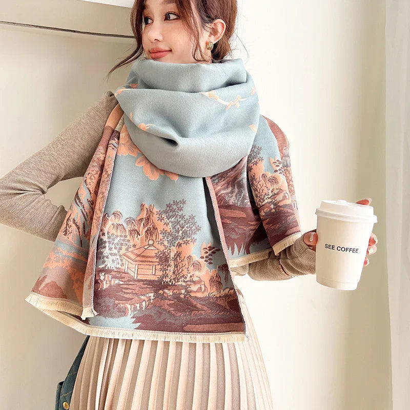Woman wearing scenic printed scarf and beige pleated skirt holding white coffee cup