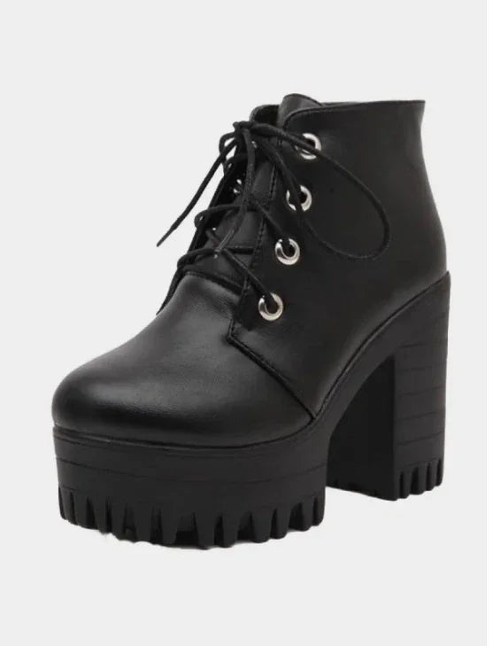 Black platform ankle boots with chunky heel and lace-up front on white background