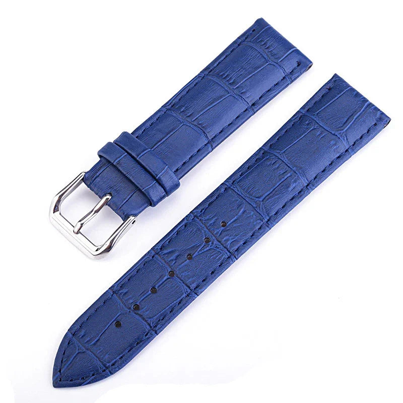 Blue leather watch strap with crocodile pattern and silver buckle on white background