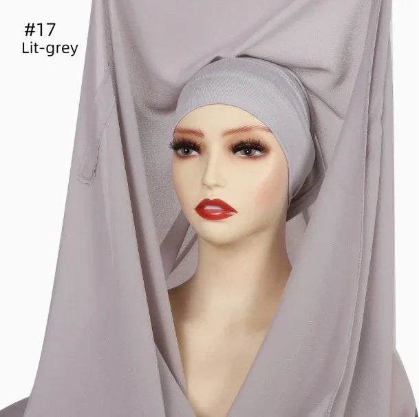 Mannequin wearing light grey hijab and matching inner cap against white background