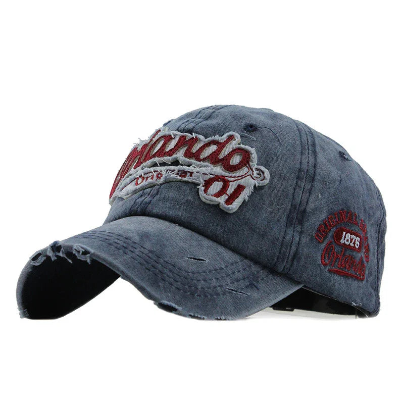 Distressed blue baseball cap with red and white Orlando 1976 embroidered patch