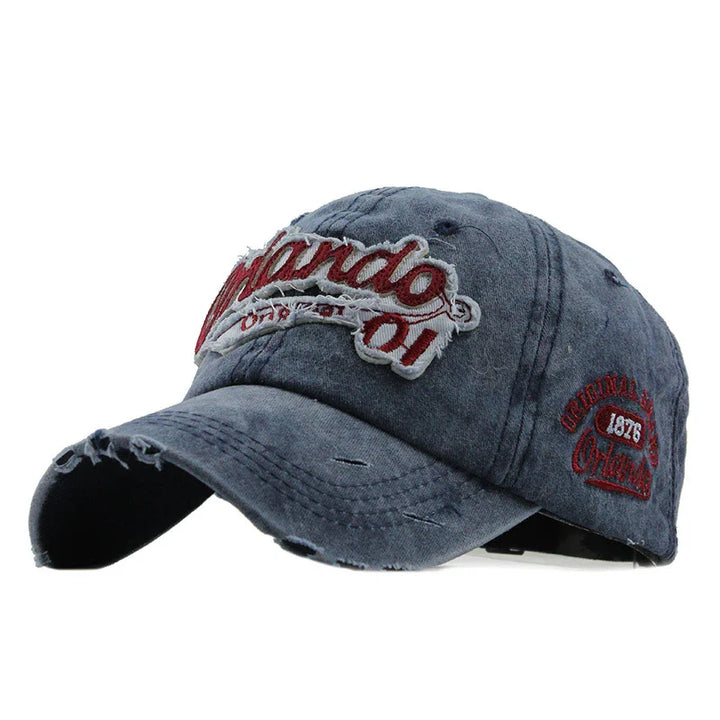 Distressed blue baseball cap with red and white Orlando 1976 embroidered patch