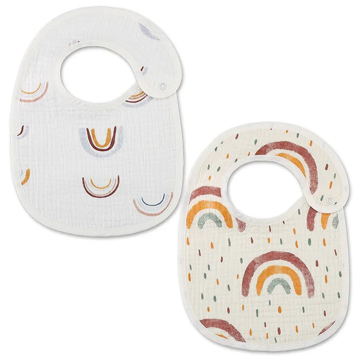 Two soft baby bibs with colorful rainbow prints and snap closures on white background