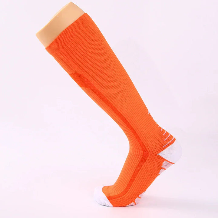 Orange knee-high sports compression sock with white accents on toe and heel