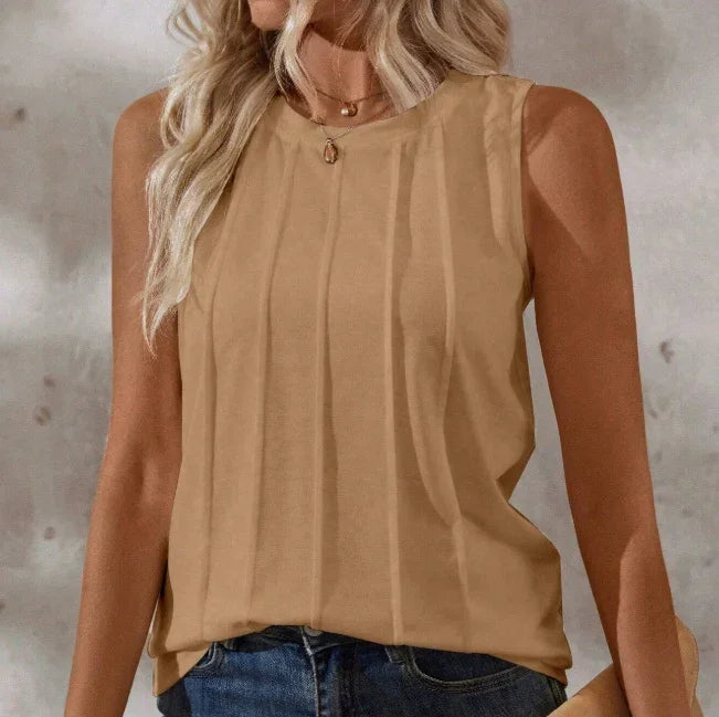Sleeveless tan top with subtle vertical stripes worn by a woman with blonde hair and blue jeans