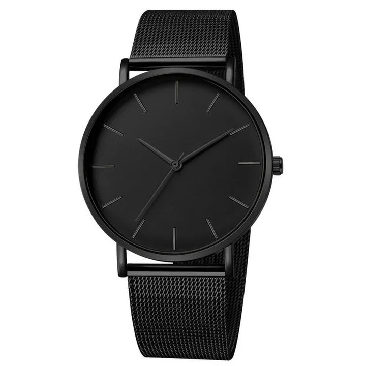 Minimalist all-black wristwatch with mesh band and simple hour markers