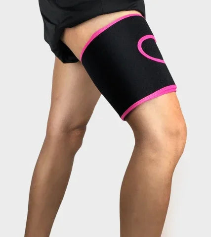 Person wearing black and pink thigh compression sleeve for support