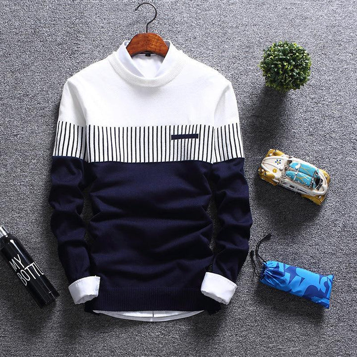 Navy blue and white turtleneck sweater with striped chest pattern on gray background